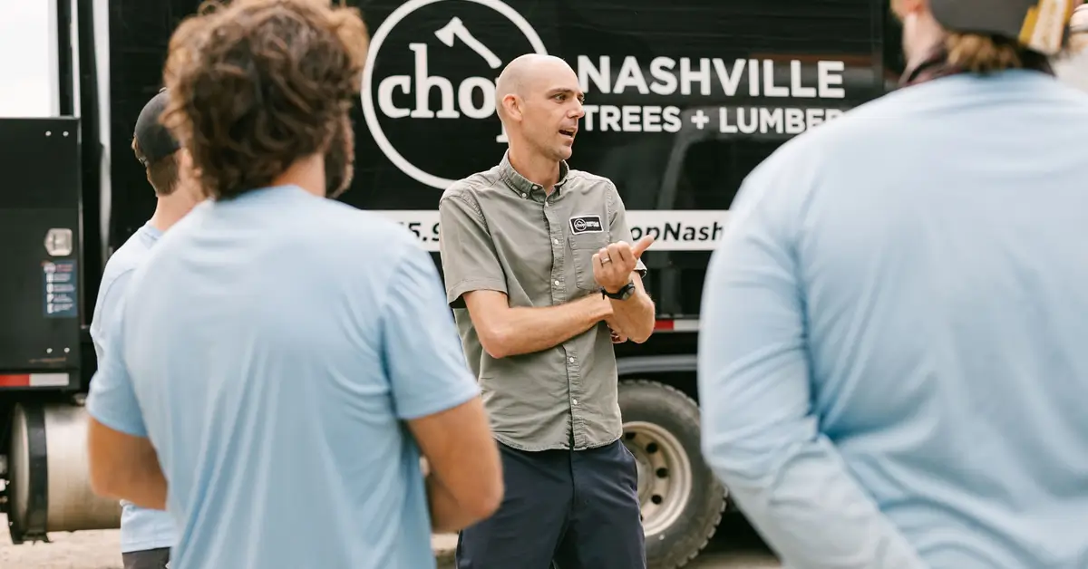 Crew leader briefing the tree crew in front of the Chop Nashville truck